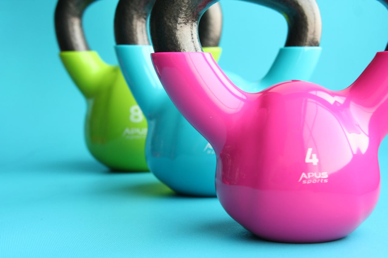 The Art of Drawing Readers In: Your attractive post title goes here Vibrant colored kettlebells on blue background highlighting fitness and exercise equipment.